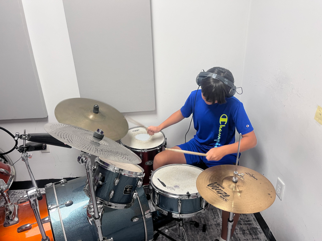 Drum player, playing the drums.